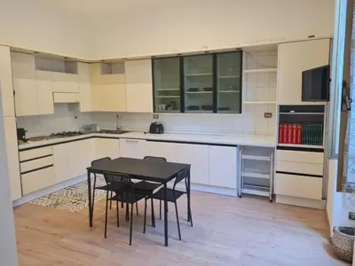 a kitchen with a table and chairs in it at testaccio sei in Rome