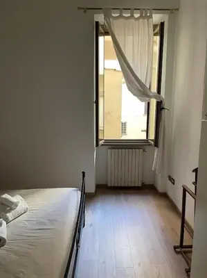an empty room with a bed and a window at testaccio sei in Rome