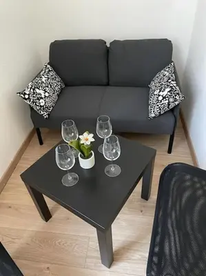 a black coffee table with three wine glasses on it at testaccio sei in Rome