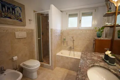 a bathroom counter with a basket of toothbrushes and a mirror at Casa Franciska in Rome