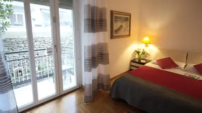 a bedroom with a bed and a large window at Casa Franciska in Rome