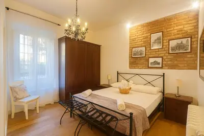 a bedroom with a bed and a brick wall at FL Suites - Vatican in Rome