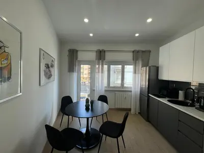 a kitchen with a table and chairs in a kitchen at Chic&Elegant Retreat in Rome in Rome