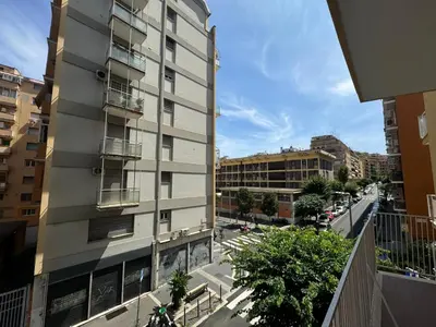 an apartment building with balconies on a city street at Chic&Elegant Retreat in Rome in Rome
