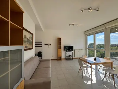 a living room with a couch and a table at Bright apt near Porta Maggiore in Rome