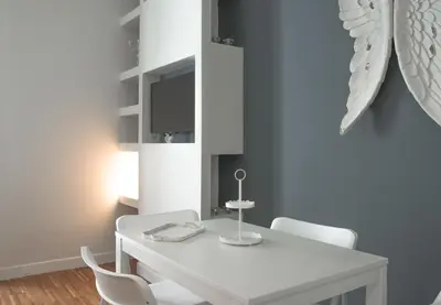 a white dining room with a white table and chairs at Vatican Angels Casa Vacanze in Rome