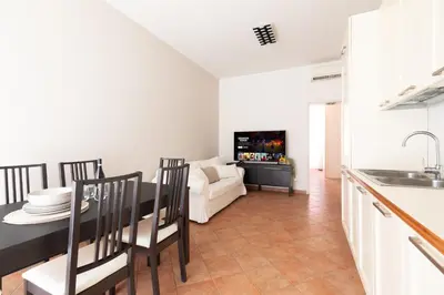 a kitchen and living room with a table and a couch at Centro - casa a Trastevere in Rome