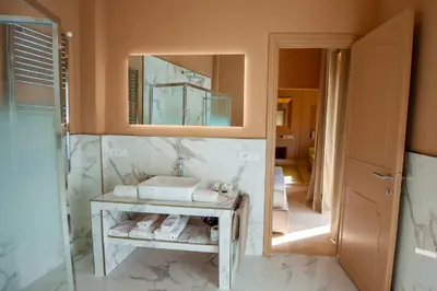 a bathroom with a sink and a mirror at Boutique Suites Valadier in Rome