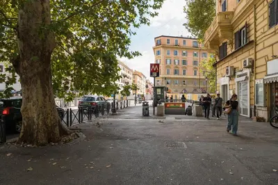 a street in a city with people walking down the street at Barletta Vatican Rooms in Rome