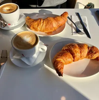 a table with a cup of coffee and croissants on it at ToniB&B in Rome