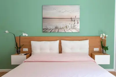 a bedroom with a bed and a painting on the wall at ToniB&B in Rome