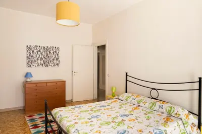 a bedroom with a bed and a dresser at Appartamento Scena Vaticana in Rome