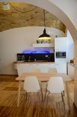 a kitchen with a table and chairs in a room at L'atelier in Rome