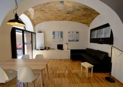 a living room with a table and a couch at L'atelier in Rome