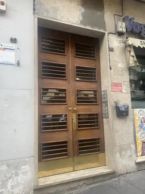 a wooden door on the side of a building at Glint House Prestige in Rome