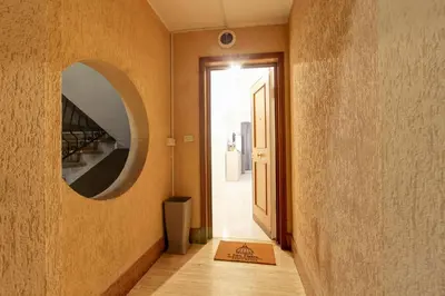 a hallway with a mirror on the wall and a door at Fermata San Pietro - appartamento con parcheggio in Rome