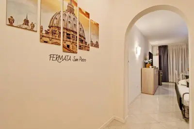 a living room with an archway leading to a bedroom at Fermata San Pietro - appartamento con parcheggio in Rome
