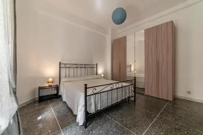 a bedroom with a bed and a large mirror at San Pietro - Musei Vaticani Appartamento spazioso in Rome