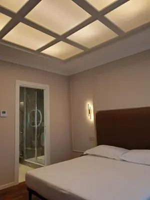 a bedroom with a bed and a coffered ceiling at Appian Private Suites in Rome