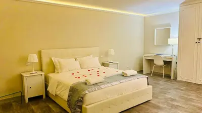 a bedroom with a large bed with red flowers on it at Maison Pantheon & Breakfast in Rome