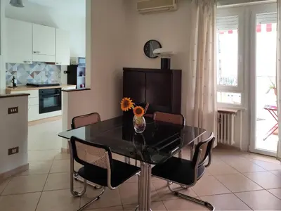 a kitchen and dining room with a black table and chairs at Oasi Ridolfi in Rome