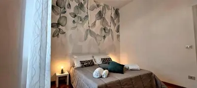 a bedroom with a bed with a painting on the wall at Casa Linda in Rome