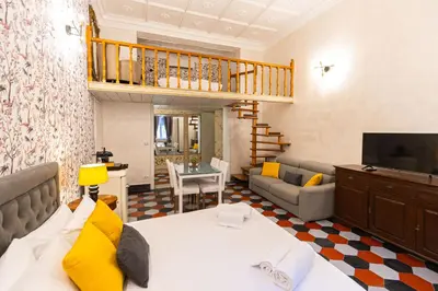 a living room with a bed and a couch at Sweet Navona Duplex Apartment in Rome
