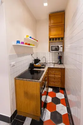a small kitchen with a sink and a microwave at Sweet Navona Duplex Apartment in Rome