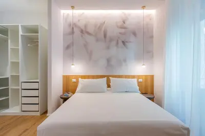 a bedroom with a large bed with white sheets at Caesar Boutique Apartment in Rome