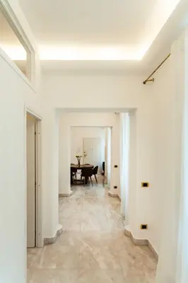 a living room with a table and white walls at Bonsignore Luxury Accomodation in Rome