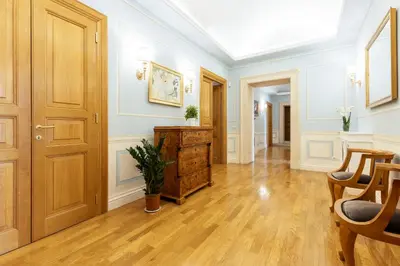 a hallway with a wooden door and wooden floors at Pantheon Suites in Rome in Rome
