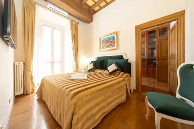 a bedroom with two beds and a window at Pantheon Suites in Rome in Rome