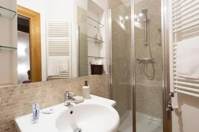 a bathroom with a sink and a shower at Pantheon Suites in Rome in Rome