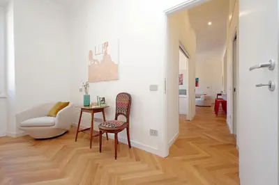 a living room with a table and a chair at Scipioni in Rome