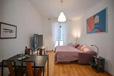 a bedroom with a bed and a table with a tableablish at Dodo House in Rome