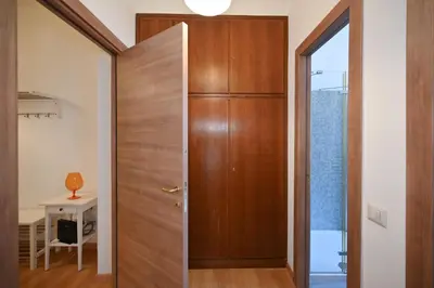 a wooden door in a room with a table at Dodo House in Rome