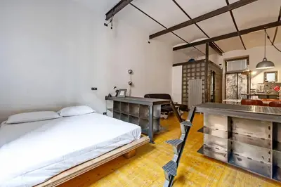a bedroom with a bed and a desk and a table at Design Loft a Roma in Rome
