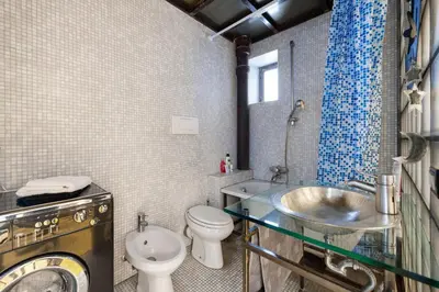 a bathroom with a sink and a toilet and a shower at Design Loft a Roma in Rome