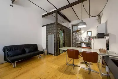 a living room with a black couch and a table at Design Loft a Roma in Rome