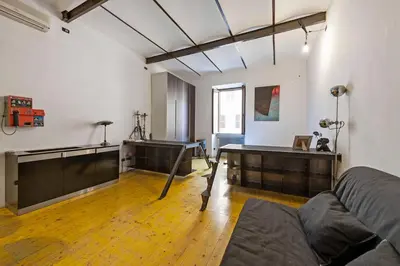 a room with a couch and a table in it at Design Loft a Roma in Rome