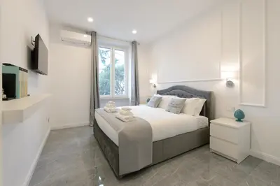 a bedroom with a large bed with a window at Domus Ludovica in Rome