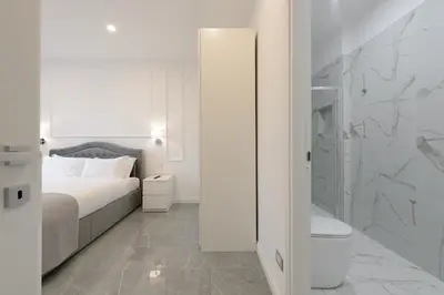 a bedroom with a bed and a toilet and a shower at Domus Ludovica in Rome
