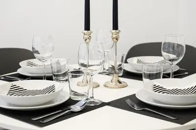 a table with plates and wine glasses on it at Domus Enrico in Rome