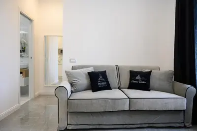 a couch in a living room with two pillows on it at Domus Enrico in Rome