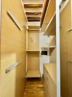 a walk in closet with wooden floors and shelves at Vetrina Roma - Stay in Luxury in Rome