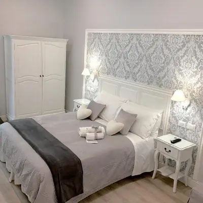 a bedroom with a large white bed with two pillows at Charme & Chic Prestige in Rome