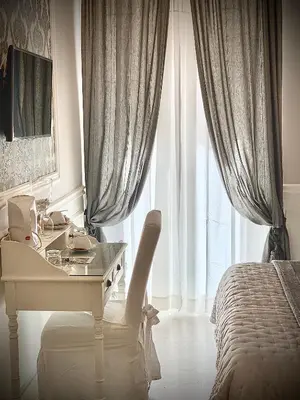 a white desk in a bedroom with a bed and a window at Charme & Chic Prestige in Rome