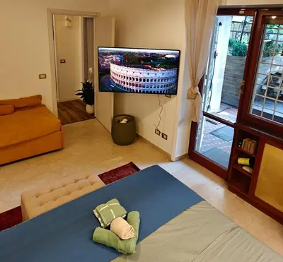 a living room with a tv and a couch at Olive Whisper Rome Garden and Sauna in Rome