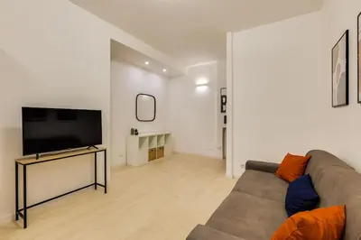 a living room with a couch and a flat screen tv at Vatican Apartment - Betty Home in Rome