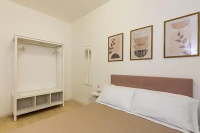a bedroom with a bed and some pictures on the wall at Vatican Apartment - Betty Home in Rome